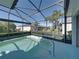 A screened-in pool with a clear view of the landscaped backyard and neighborhood at 5340 Nicklaus Dr, Winter Haven, FL 33884