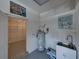View of the utility room including a water heater, utility sink, and shelving space at 5340 Nicklaus Dr, Winter Haven, FL 33884