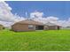 Lush green backyard with a screened-in lanai, offering privacy and space for outdoor enjoyment at 5751 Lakeside Landings Blvd, Winter Haven, FL 33881