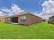 Expansive backyard featuring a screened lanai, providing ample space for outdoor activities and relaxation at 5751 Lakeside Landings Blvd, Winter Haven, FL 33881