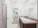 Bathroom featuring double sinks, a mirror, and a door leading to the laundry room at 5751 Lakeside Landings Blvd, Winter Haven, FL 33881