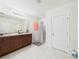 Bathroom featuring double vanity, tile flooring, and glass-enclosed shower at 5751 Lakeside Landings Blvd, Winter Haven, FL 33881