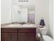Bathroom showcasing a double sink vanity, a toilet, and neutral walls at 5751 Lakeside Landings Blvd, Winter Haven, FL 33881