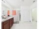 Bathroom featuring double vanity, tile flooring, and glass-enclosed shower at 5751 Lakeside Landings Blvd, Winter Haven, FL 33881
