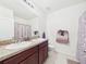 Bathroom featuring a double sink vanity, a mirror, and tile flooring at 5751 Lakeside Landings Blvd, Winter Haven, FL 33881