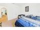 Comfortable bedroom with neutral walls and carpet, and a large bed at 5751 Lakeside Landings Blvd, Winter Haven, FL 33881