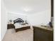 Spacious carpeted bedroom with stylish dark wood furniture and bright natural light at 5751 Lakeside Landings Blvd, Winter Haven, FL 33881