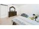 Comfortable bedroom featuring a bed with a decorative headboard and a dresser at 5751 Lakeside Landings Blvd, Winter Haven, FL 33881