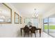 Dining room features sliding glass doors, neutral walls, and tile floors at 5751 Lakeside Landings Blvd, Winter Haven, FL 33881