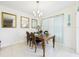 Dining area with dark wooden table, set for dinner, and three mirrors at 5751 Lakeside Landings Blvd, Winter Haven, FL 33881