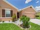 Charming single-story home with a two-car garage, beautiful landscaping, and a welcoming entrance at 5751 Lakeside Landings Blvd, Winter Haven, FL 33881