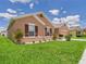 Charming single-Gathering home featuring manicured landscaping, a well-maintained lawn, and appealing exterior details at 5751 Lakeside Landings Blvd, Winter Haven, FL 33881