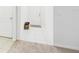 Clean foyer with white walls, tile floors, and a decorative rug near the front door at 5751 Lakeside Landings Blvd, Winter Haven, FL 33881
