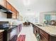 Spacious kitchen with wooden cabinets and open view to dining area at 5751 Lakeside Landings Blvd, Winter Haven, FL 33881