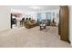 Open-concept living room flowing into the kitchen, featuring modern furniture and bright light at 5751 Lakeside Landings Blvd, Winter Haven, FL 33881