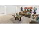 Inviting living room with a comfortable sofa, coffee table, and open access to the kitchen area at 5751 Lakeside Landings Blvd, Winter Haven, FL 33881