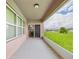 View of screened back patio with outdoor view and dining room entrance at 5751 Lakeside Landings Blvd, Winter Haven, FL 33881