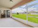 View of screened in back patio overlooking expansive yard and pond at 5751 Lakeside Landings Blvd, Winter Haven, FL 33881