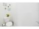 Bright half bathroom with an efficient toilet and simple decor at 5751 Lakeside Landings Blvd, Winter Haven, FL 33881