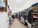 Spacious walk-in closet with ample storage, built-in shelving, and carpeted flooring at 5751 Lakeside Landings Blvd, Winter Haven, FL 33881