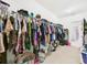 Bright walk-in closet featuring extensive hanging space and carpeted floors at 5751 Lakeside Landings Blvd, Winter Haven, FL 33881