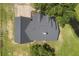 Aerial view of a charming home with a dark roof and a sprawling lawn with beautiful trees at 5820 E Johnson Ave, Haines City, FL 33844