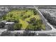 Expansive aerial view showcases the large lot with a creek, mature trees, and a home at 5820 E Johnson Ave, Haines City, FL 33844