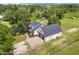 Aerial view of a charming home with a sprawling lawn and beautiful trees at 5820 E Johnson Ave, Haines City, FL 33844