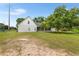 Image of the home's backyard, with a screened-in porch and lush greenery at 5820 E Johnson Ave, Haines City, FL 33844