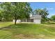 View of the home's backyard with a screened-in porch and grassy area at 5820 E Johnson Ave, Haines City, FL 33844