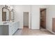 Modern bathroom with double sink vanity, tiled floors and shower at 5820 E Johnson Ave, Haines City, FL 33844