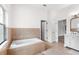 Bright bathroom featuring tiled floors, bathtub and vanity at 5820 E Johnson Ave, Haines City, FL 33844