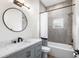 This bathroom offers tiled walls, modern hardware, and a shower-tub combo with great lighting at 5820 E Johnson Ave, Haines City, FL 33844