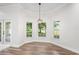 Charming dining area with hardwood floors, natural light, and a modern pendant light fixture at 5820 E Johnson Ave, Haines City, FL 33844