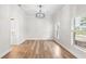 Bright dining room with hardwood floors, a modern chandelier, and large windows with natural light at 5820 E Johnson Ave, Haines City, FL 33844