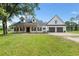 Lovely two-story home featuring a well-manicured lawn, front porch, and an attached two-car garage at 5820 E Johnson Ave, Haines City, FL 33844