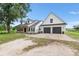 Attractive home with a spacious driveway, a two-car garage, and a charming front porch at 5820 E Johnson Ave, Haines City, FL 33844
