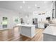 Spacious open-concept kitchen with white cabinets, marble countertops, stainless steel appliances, and a stylish central island at 5820 E Johnson Ave, Haines City, FL 33844