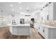 Bright kitchen featuring white cabinetry, stainless steel appliances, marble countertops, and a center island with modern faucet at 5820 E Johnson Ave, Haines City, FL 33844