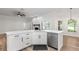 Modern kitchen featuring white cabinets, stainless steel appliances, an island with a sink, and an open layout at 5820 E Johnson Ave, Haines City, FL 33844