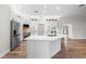 Bright kitchen featuring a central island with white countertops and stainless steel appliances at 5820 E Johnson Ave, Haines City, FL 33844