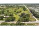 Aerial view showcasing the home's expansive lot with mature trees and a serene pond at 5820 E Johnson Ave, Haines City, FL 33844