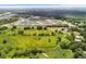 Aerial view of large lot with a small pond and a few trees at 5820 E Johnson Ave, Haines City, FL 33844