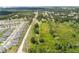 Aerial view of a large field with green grass and scattered trees, with houses in the distance at 5820 E Johnson Ave, Haines City, FL 33844