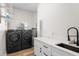 Spacious laundry room with updated appliances, storage, and a sink at 5820 E Johnson Ave, Haines City, FL 33844