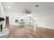 Open living space showcasing the white kitchen with a large island and a stone fireplace at 5820 E Johnson Ave, Haines City, FL 33844