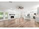 Open-concept living area with a stone fireplace, French doors, and a modern kitchen at 5820 E Johnson Ave, Haines City, FL 33844