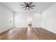 Bright main bedroom featuring hardwood floors, neutral walls and ensuite bathroom at 5820 E Johnson Ave, Haines City, FL 33844