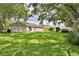 The large backyard includes mature trees and a grassy lawn perfect for outdoor enjoyment at 6028 Hillside Heights Dr, Lakeland, FL 33812