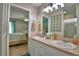 Light and bright bathroom features double sinks with a view into the bedroom at 6028 Hillside Heights Dr, Lakeland, FL 33812